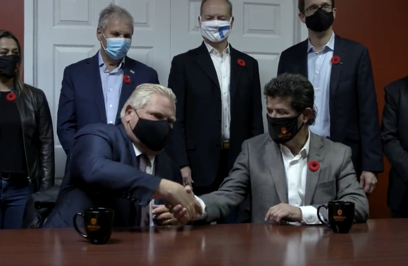 Doug Ford and Unifor President Jerry Dias shake hands.