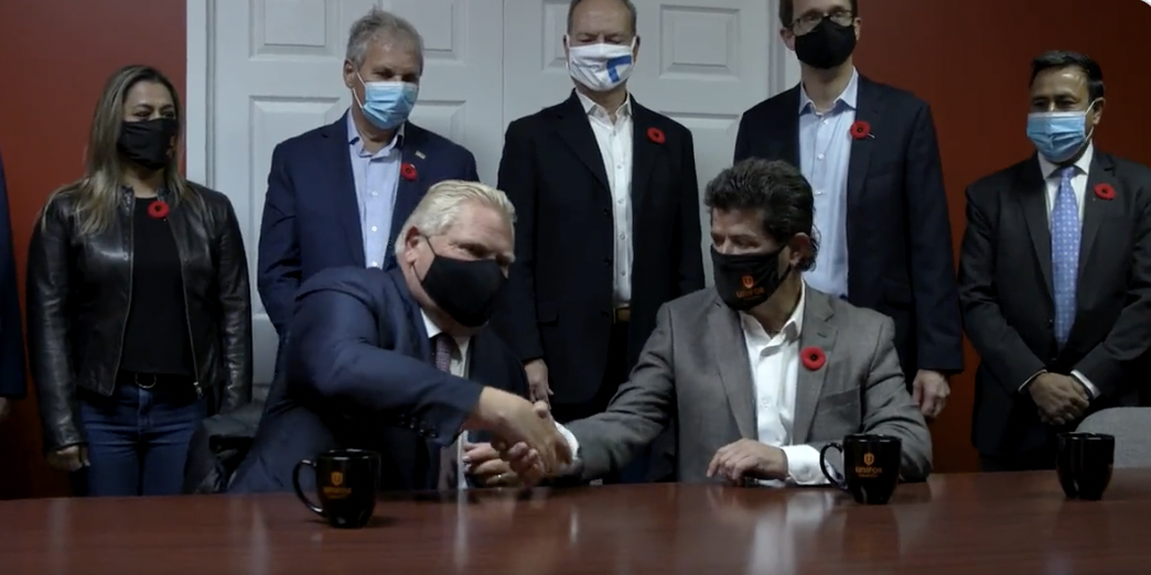 Doug Ford and Unifor President Jerry Dias shake hands.