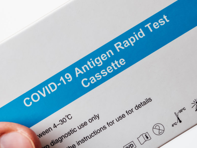 Man holding a box of Antigen rapid test for COVID-19. Photo: Ivan Radic