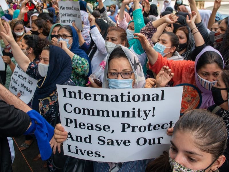 New Delhi, India, Aug 24 2021: Afghan women holding placards and shouting slogans, Afghans living in India gathered at UNHCR to protest and demand refugee status.