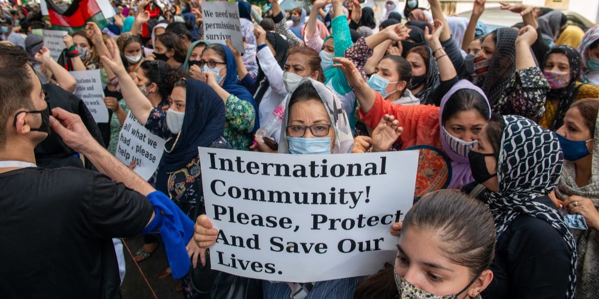 New Delhi, India, Aug 24 2021: Afghan women holding placards and shouting slogans, Afghans living in India gathered at UNHCR to protest and demand refugee status.