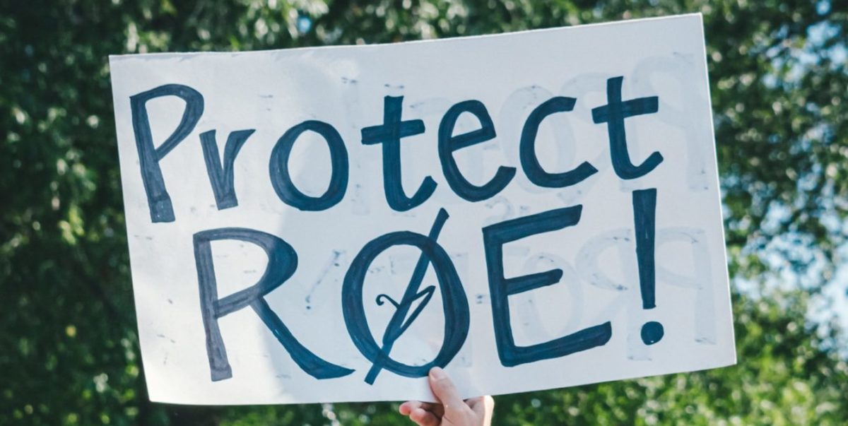 A protestor carries a poster that read "Protect Roe."