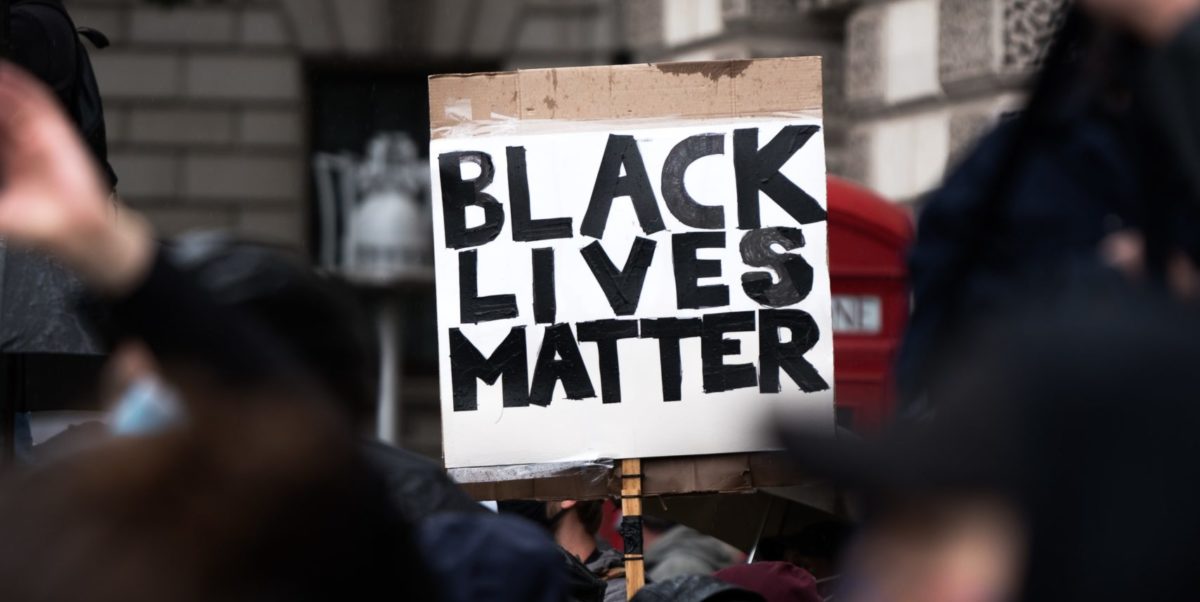 Photo of a sign at a protest which reads "Black Lives Matter"