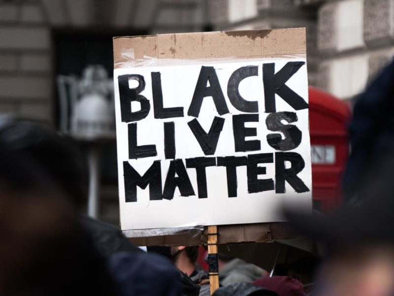 Photo of a sign at a protest which reads "Black Lives Matter"