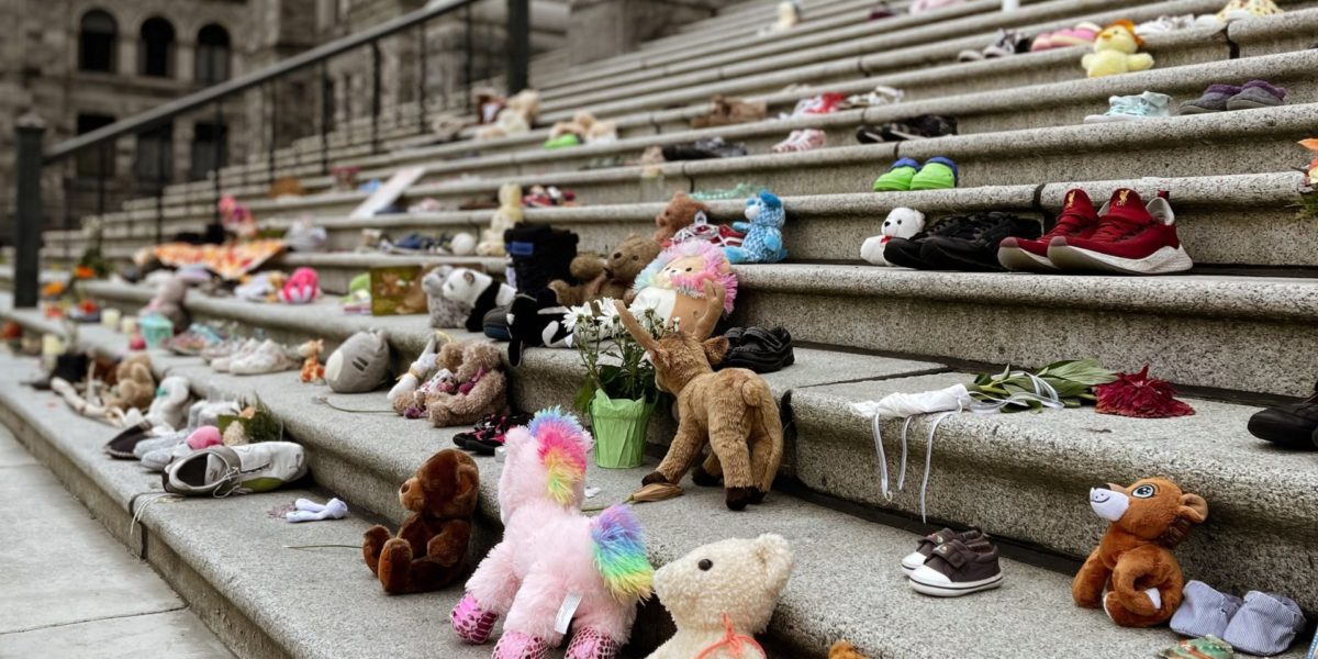 Photo of Stuffed animals laid out to honour the lives of Indigenous children lost to genocidal residential schools.