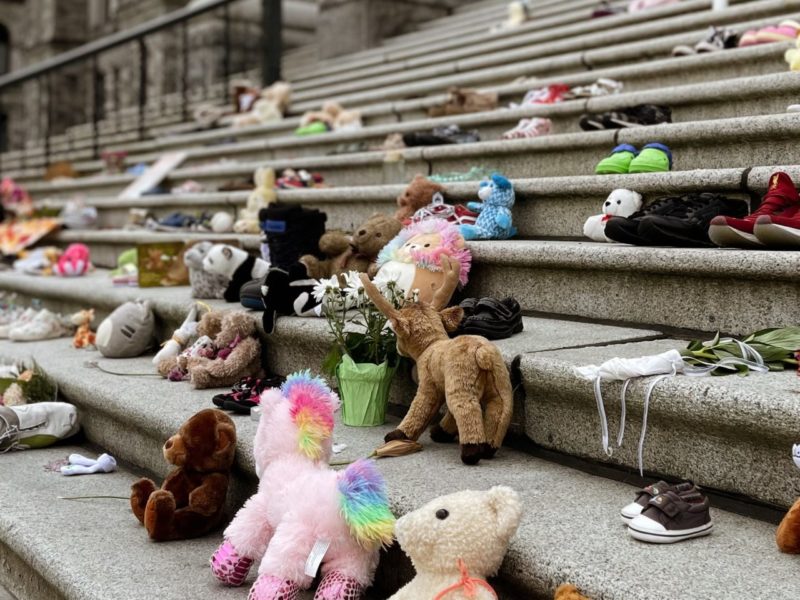 Photo of Stuffed animals laid out to honour the lives of Indigenous children lost to genocidal residential schools.