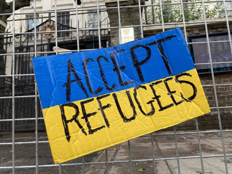 Photo of a sign reading "accept refugees" with the colours of the Ukrainian flag. Photo: