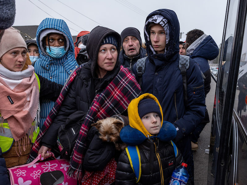 Photo of a group of Ukranian refugees boarding a bus to Poland