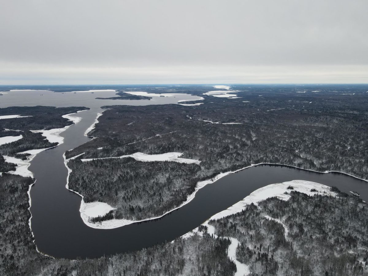 Aerial photo of a river in Long Point First Nation during the winter with snow.