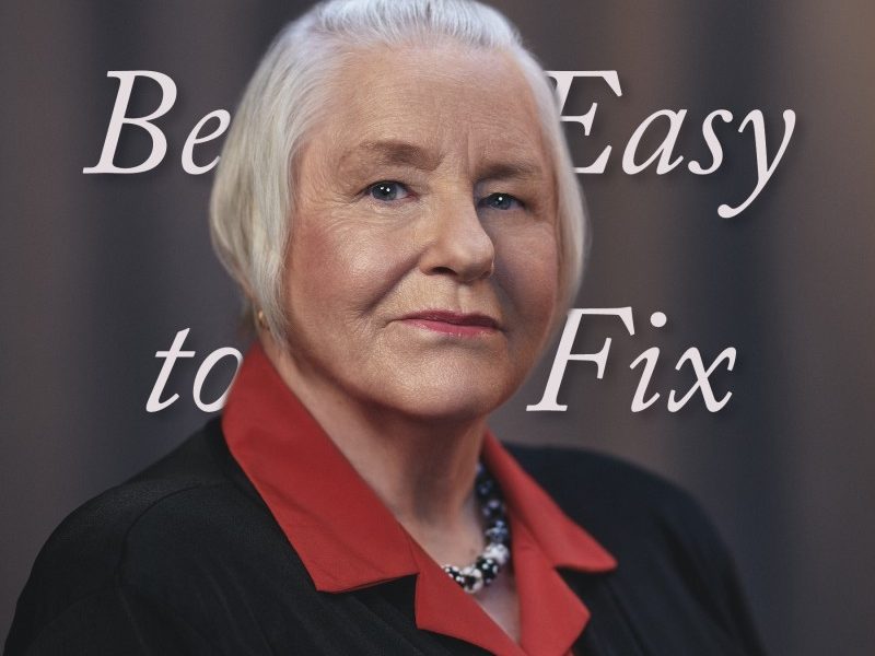 Photo of Bonnie Robichaud with the cover of a book reading words "it should be easy to fix" behind her