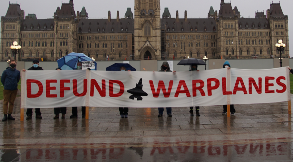 Protesters during a demonstration opposing the funding and use of warplanes.