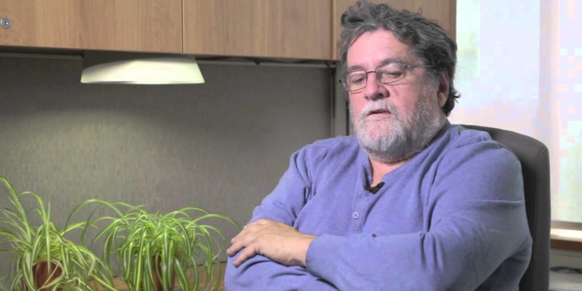 Photo of Pierre Beaudet sitting at a desk setting being interview.