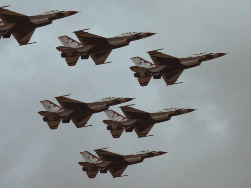 Photo of six fighter jets flying in the sky in a 'v' formation.