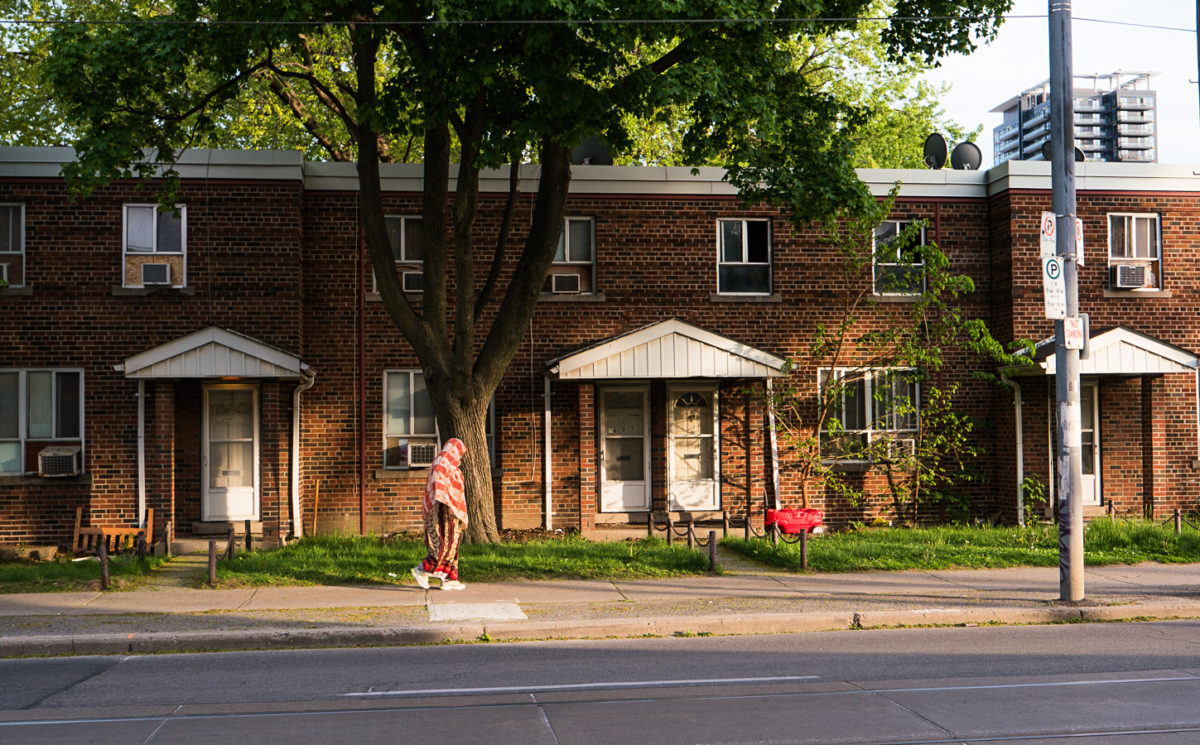 Row of house with passerby.