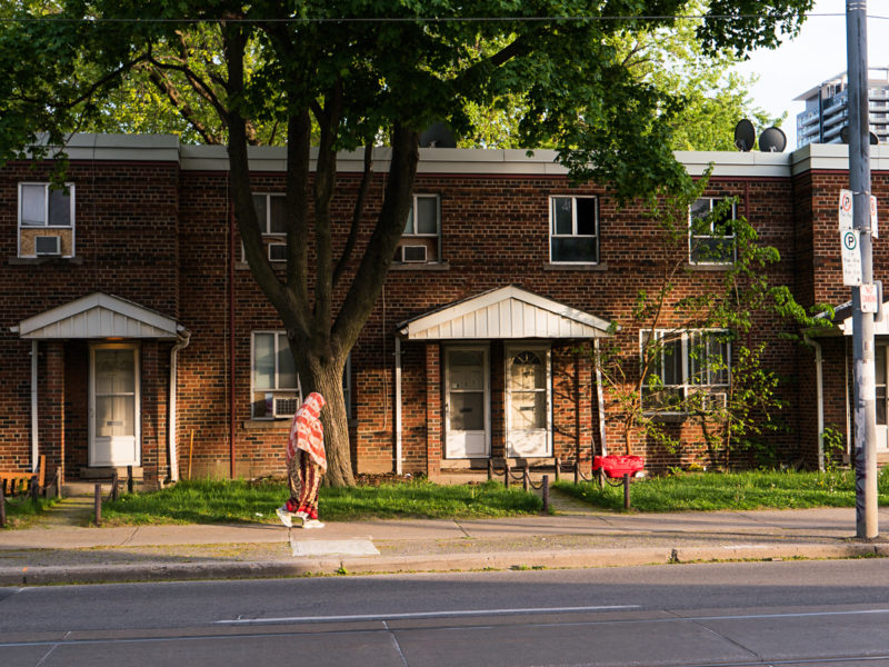 Row of house with passerby.