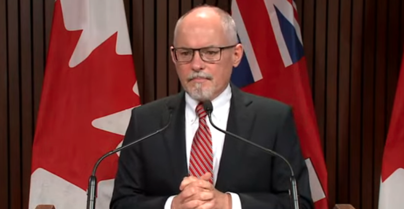 Image shows Ontario Chief Medical Officer of Health Dr. Kieran Moore speaking at an announcement on Ontario's plans for the return to in-person learning, including masking mandates.