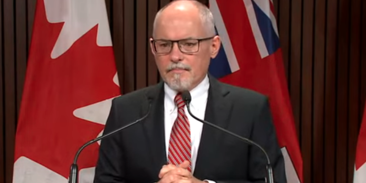 Image shows Ontario Chief Medical Officer of Health Dr. Kieran Moore speaking at an announcement on Ontario's plans for the return to in-person learning, including masking mandates.