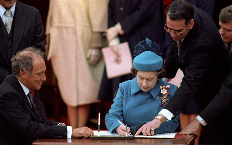 Photo of Queen Elizabeth signing the Canadian Constitution 1982.