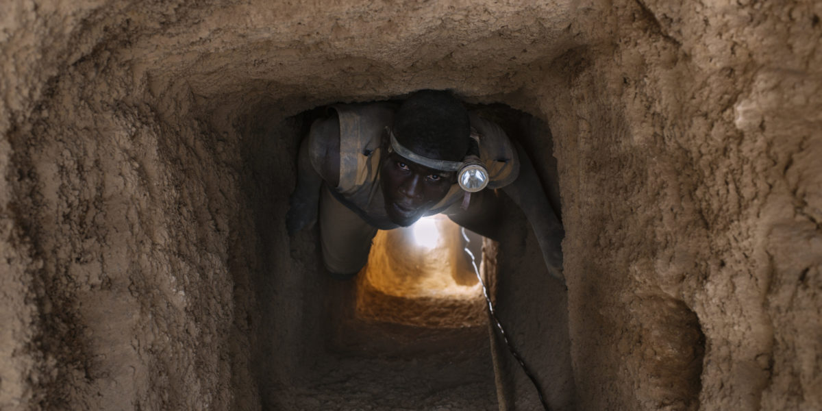 A photo of a worker inside a gold mine in Burkina Faso, similar to the mines operated by Canadian companies.