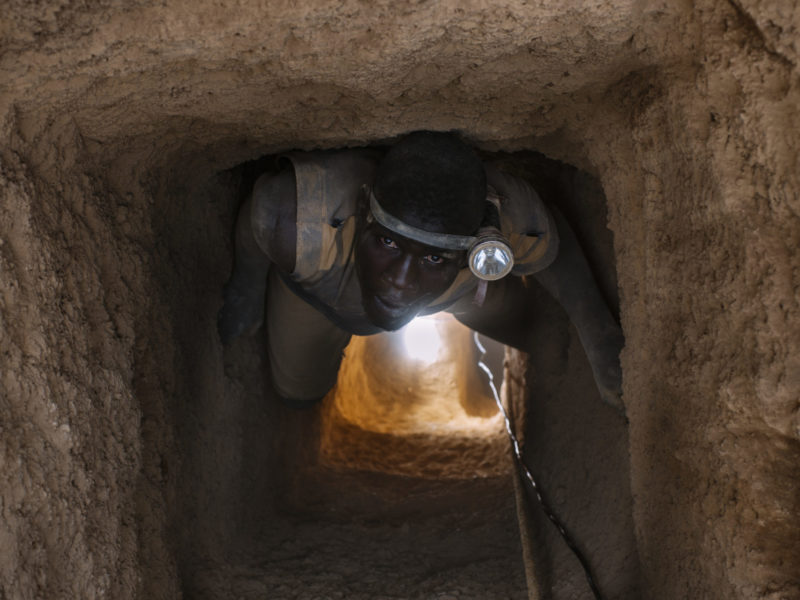 A photo of a worker inside a gold mine in Burkina Faso, similar to the mines operated by Canadian companies.