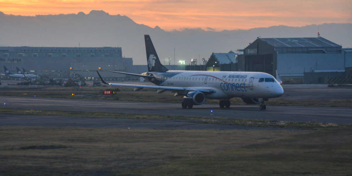 A photo of an AeroMexico jet on the tarmac at sunset.