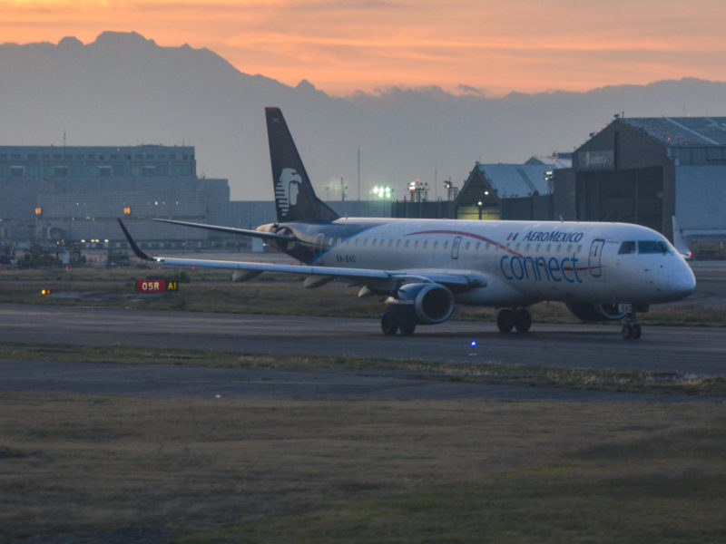 A photo of an AeroMexico jet on the tarmac at sunset.