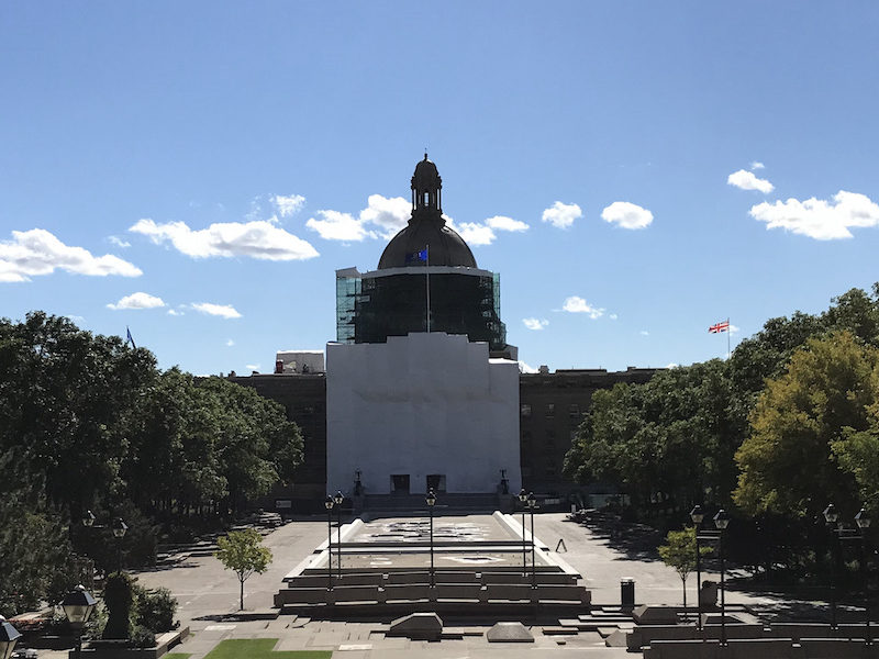 A photo of the Alberta Legislature shrouded in canvas. An Alberta Legislatur committee recently received a report on safe drug supply programs that is being criticized by other experts in the field.