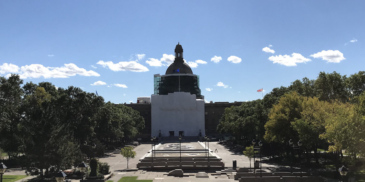 A photo of the Alberta Legislature shrouded in canvas. An Alberta Legislatur committee recently received a report on safe drug supply programs that is being criticized by other experts in the field.