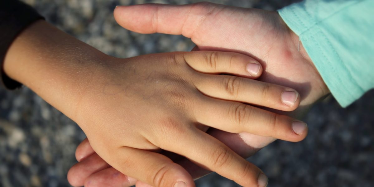 A stock image of holding hands.