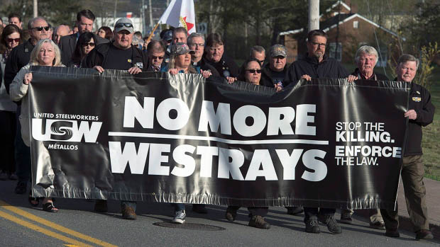 people marching and holding a banner reading no more Westrays