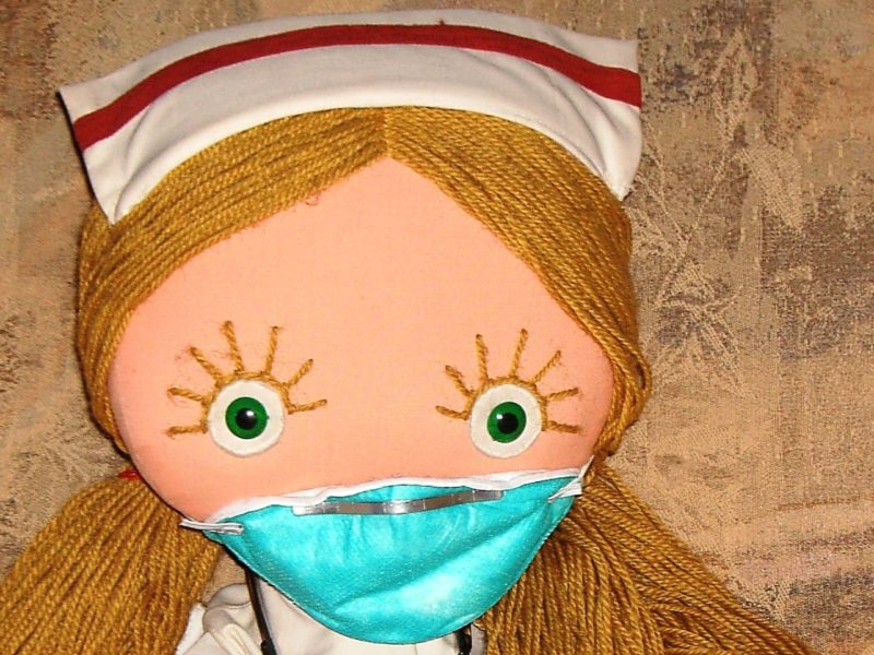 A photo of a nurse doll. For Nursing Week, support your local nurses as they organize for adequate funding and working conditions.