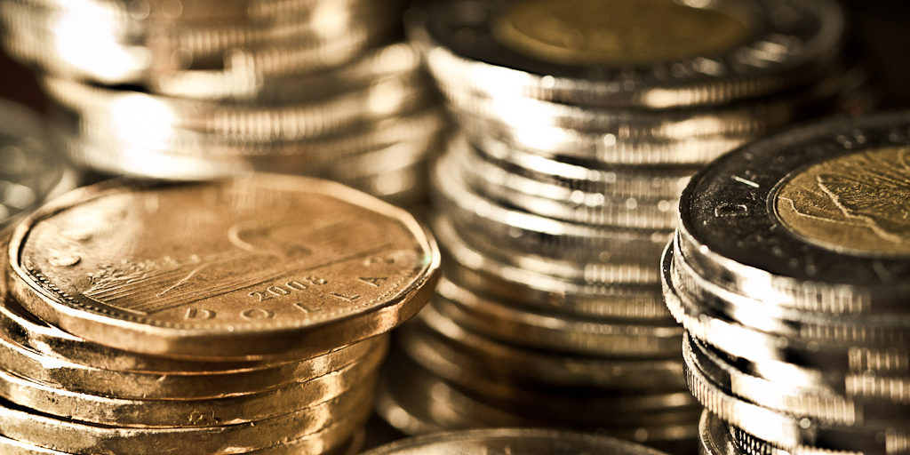 A photo of a pile of loonies and toonies.