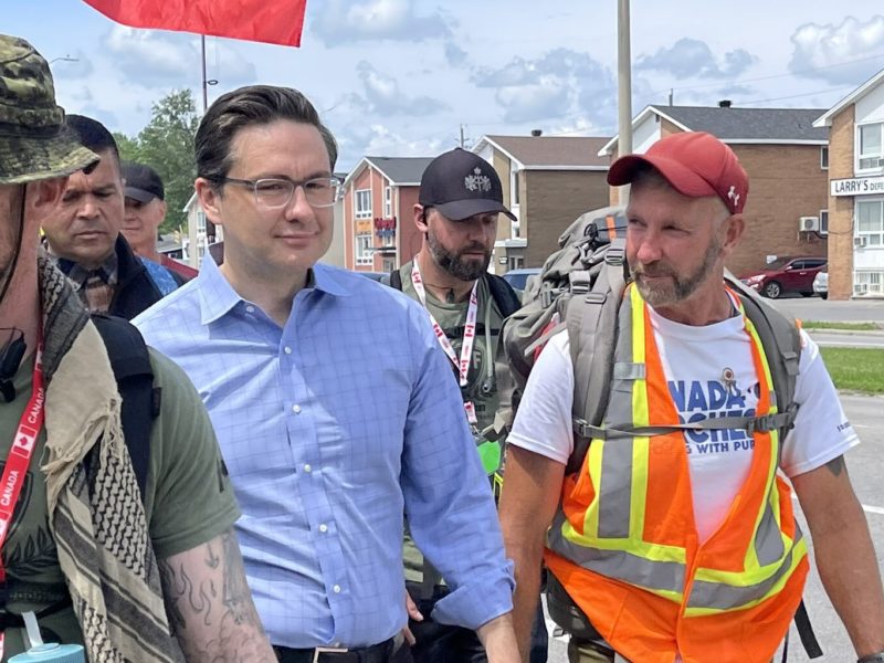 Photo of Pierre Poilievre and James Topp marching in Ottawa