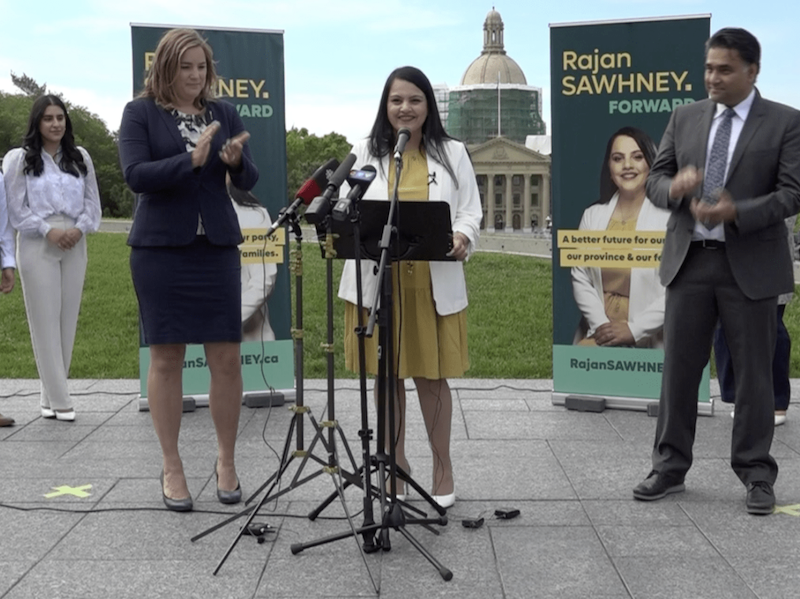 A photo of Calgary-North East MLA Rajan Sawhney announces her intention to seek Premier Jason Kenney’s job in front of the Alberta Legislature yesterday, as her campaign chair, Airdrie-East MLA Angela Pitt, applauds.