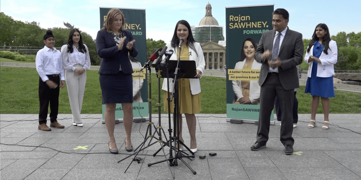 A photo of Calgary-North East MLA Rajan Sawhney announces her intention to seek Premier Jason Kenney’s job in front of the Alberta Legislature yesterday, as her campaign chair, Airdrie-East MLA Angela Pitt, applauds.