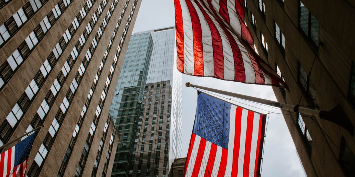 A photo of high towers and American flags