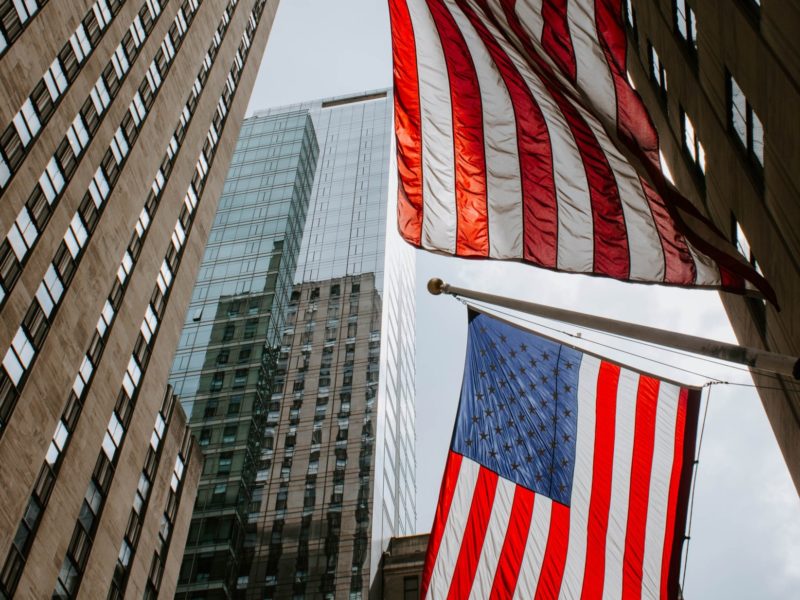 A photo of high towers and American flags