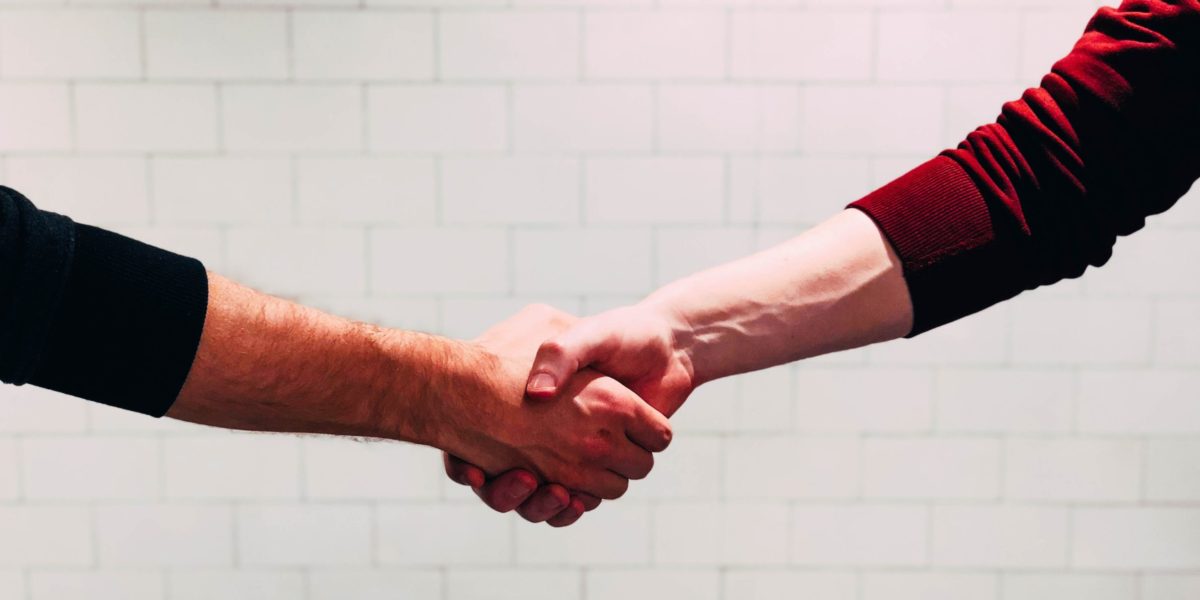 A photo of two people shaking hands