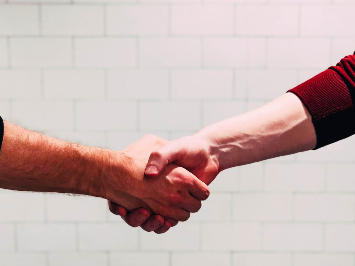 A photo of two people shaking hands