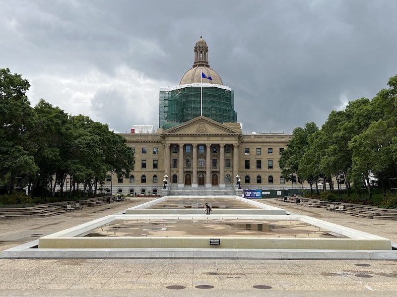 A photo of The Alberta Legislative Building under a stormy summer sky.