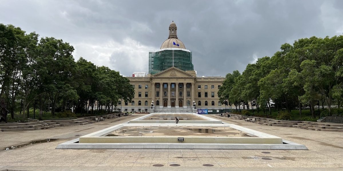 A photo of The Alberta Legislative Building under a stormy summer sky.