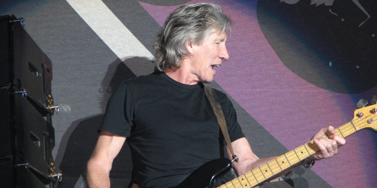 A photo of rock star Roger Waters performing on stage.