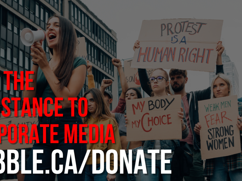 A photo of protestors with 'join the resistance' for media democracy text