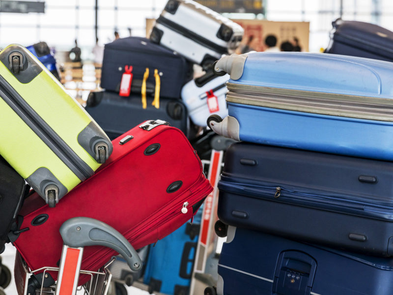 Image of a large pile of luggage at the airport.