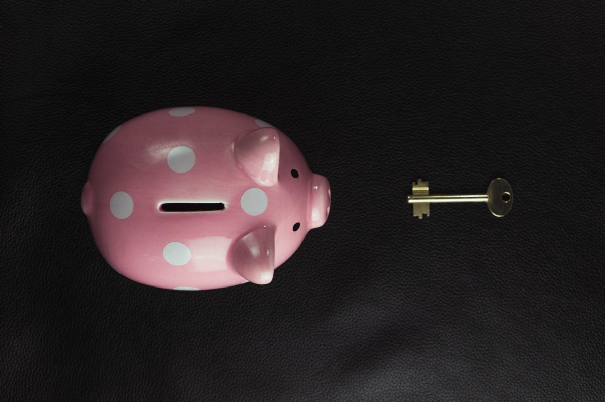 A photo of a piggy bank and a key to open it laying in front of him.