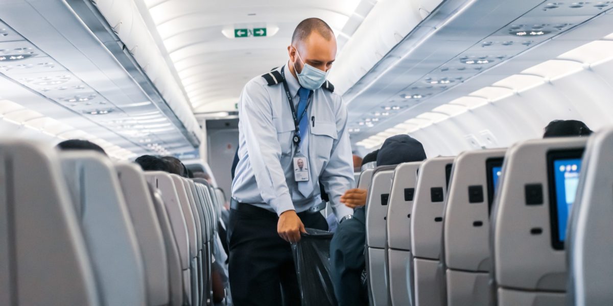 A photo of a masked flight attendant.