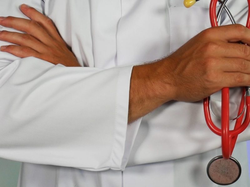 A photo of a physician holding a stethoscope.