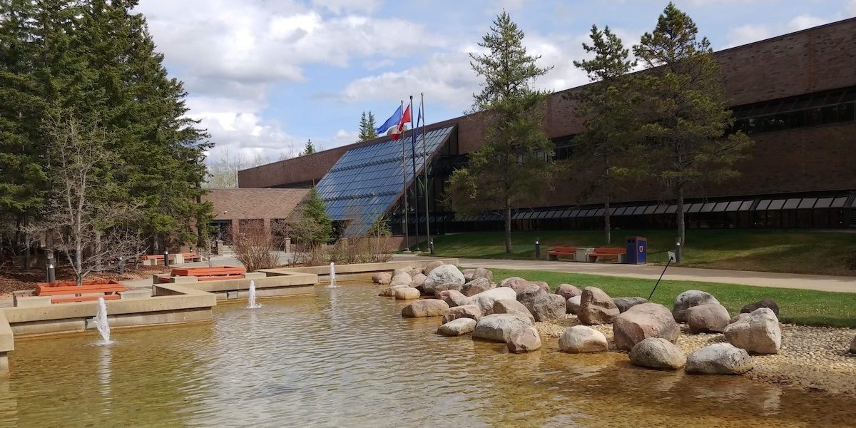 A photo of the entrance to Athabasca University’s now mostly empty administration building just west of the Town of Athabasca