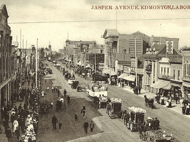 A black and white photo of Edmonton’s Labour Day Parade moves along Jasper Avenue in 1910.
