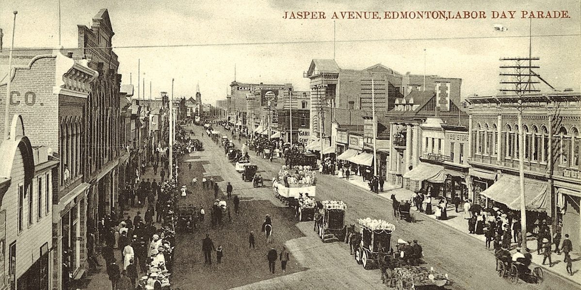 A black and white photo of Edmonton’s Labour Day Parade moves along Jasper Avenue in 1910.